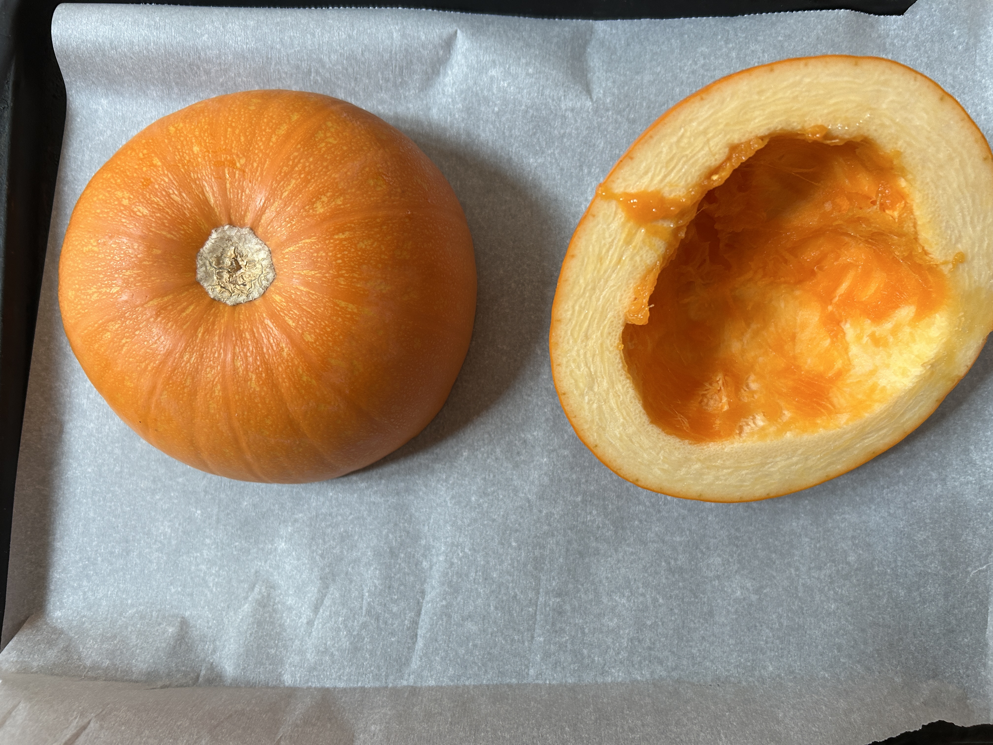 a pumpkin that has been baked in the oven on a tray