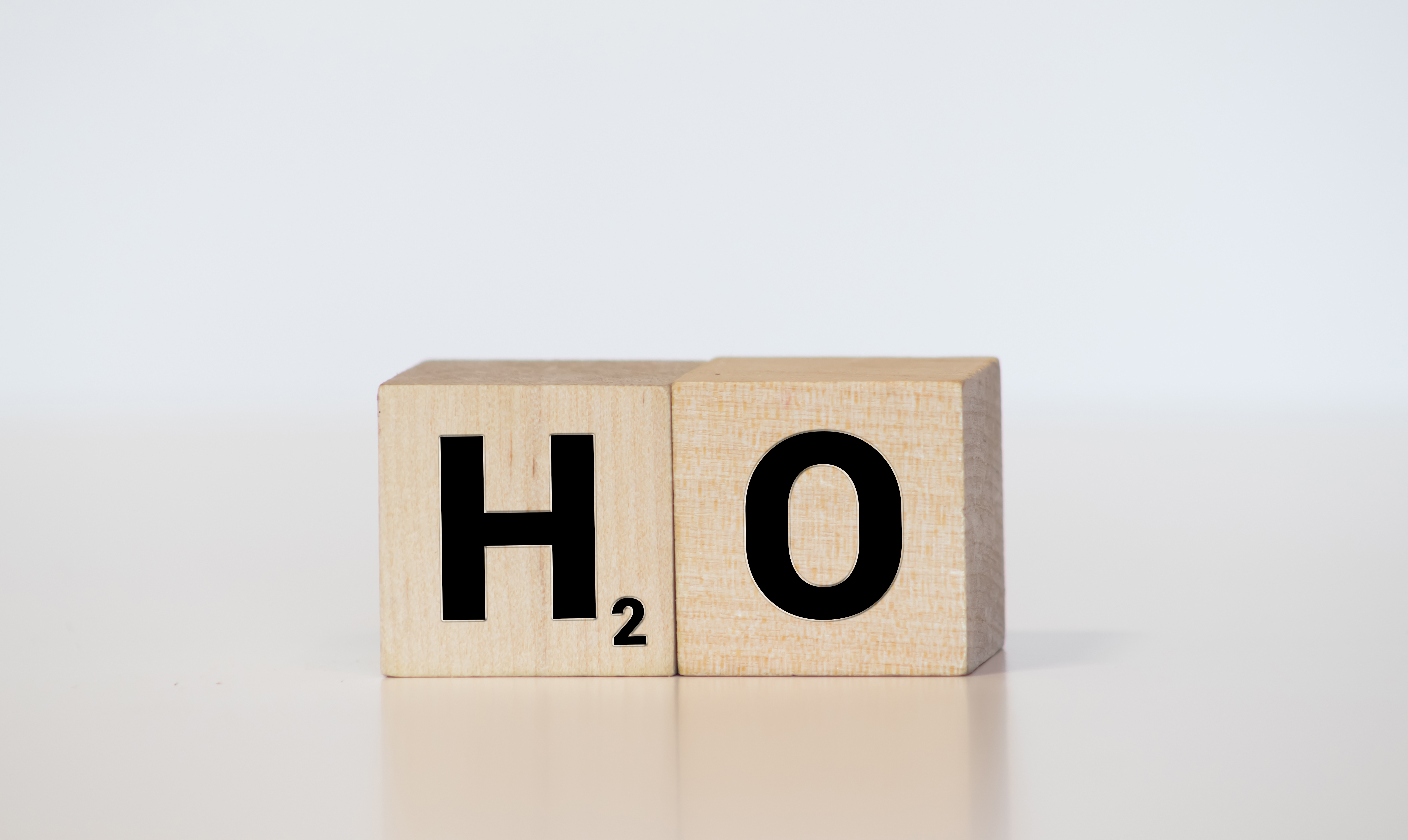 H2O symbol on wooden scrabble tiles