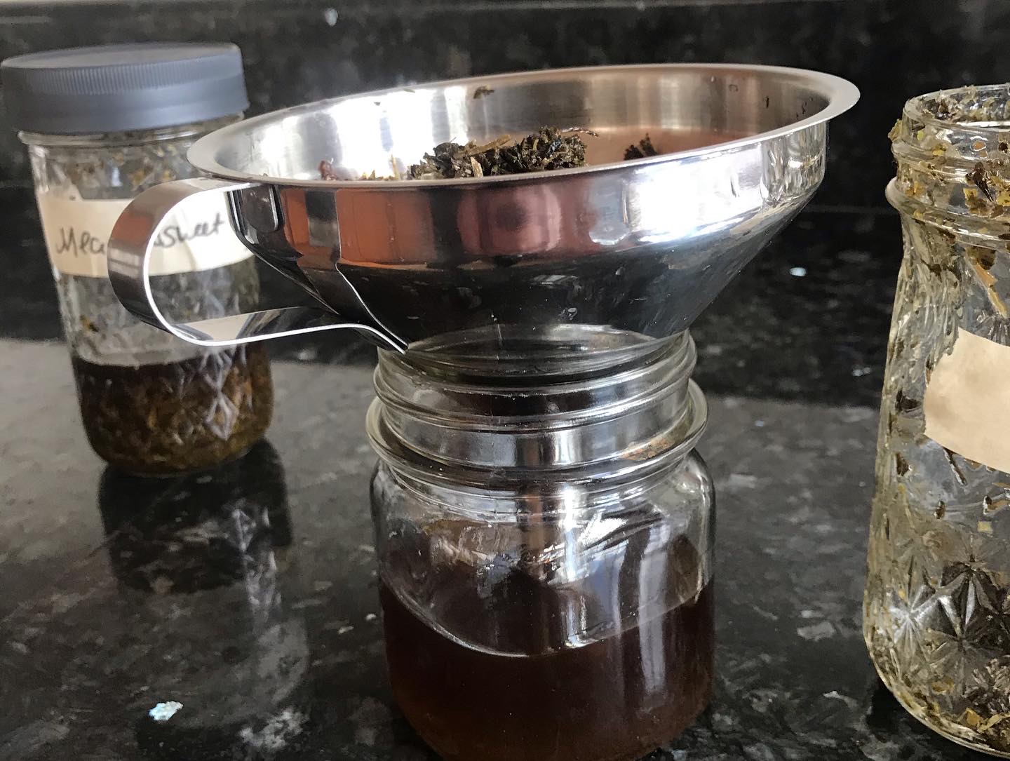 Dried herbs being made into a tincture 
