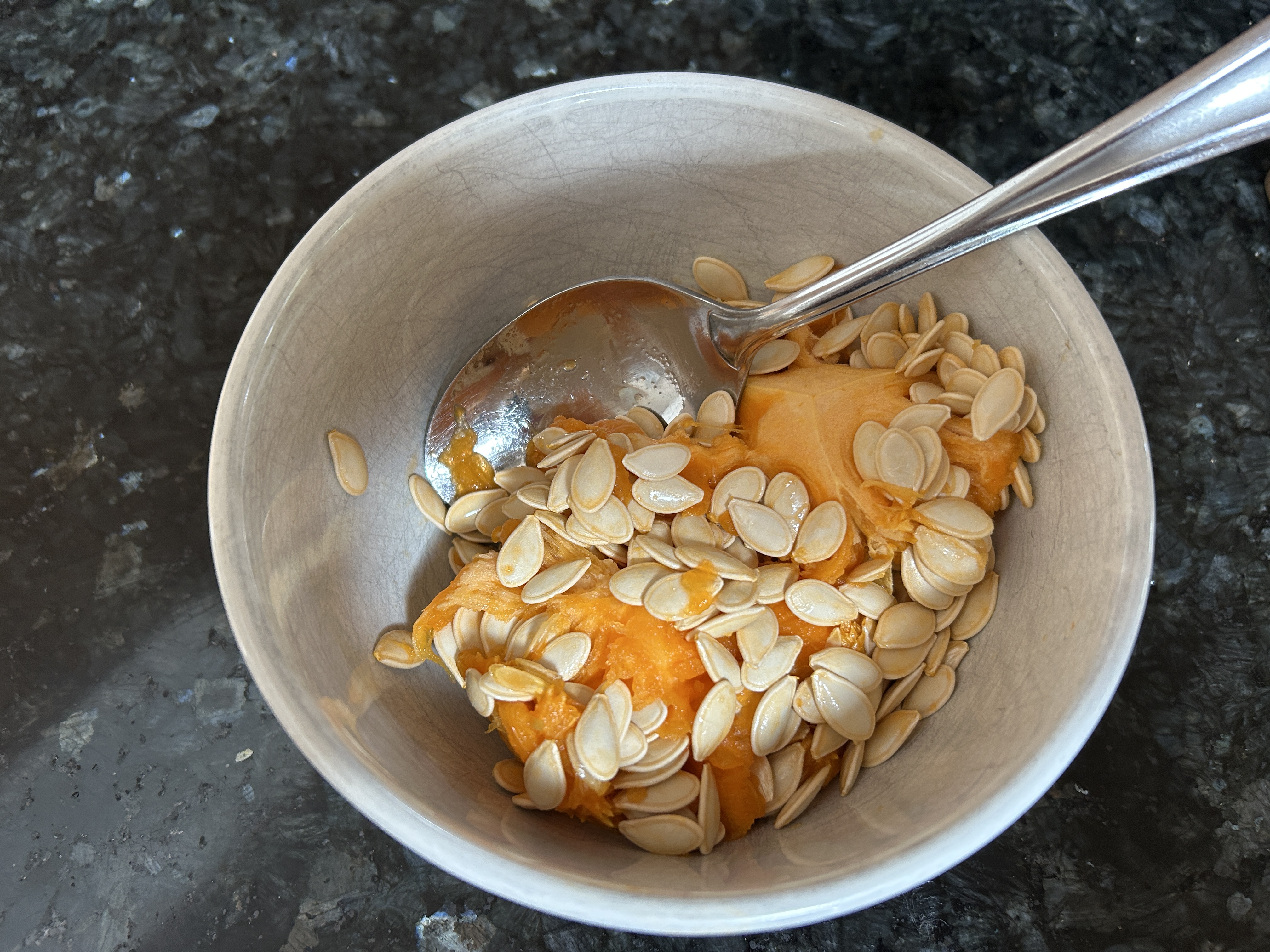 scooped out pumpkin seeds in a bowl 